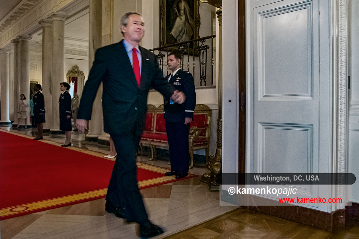 President George W. Bush enters the East Room