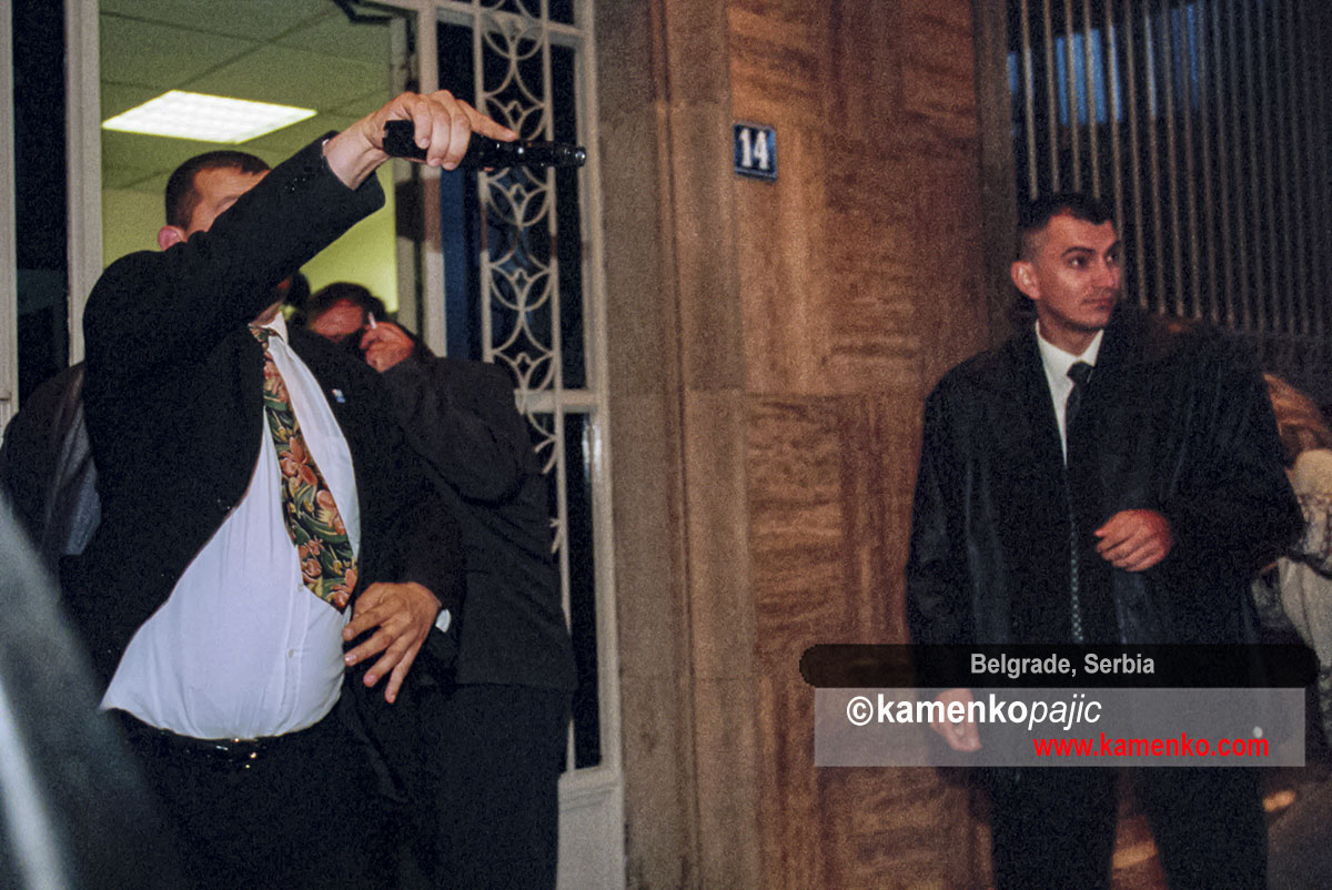 Bodyguard draws a gun at the main entrance of the Serbian Parliament