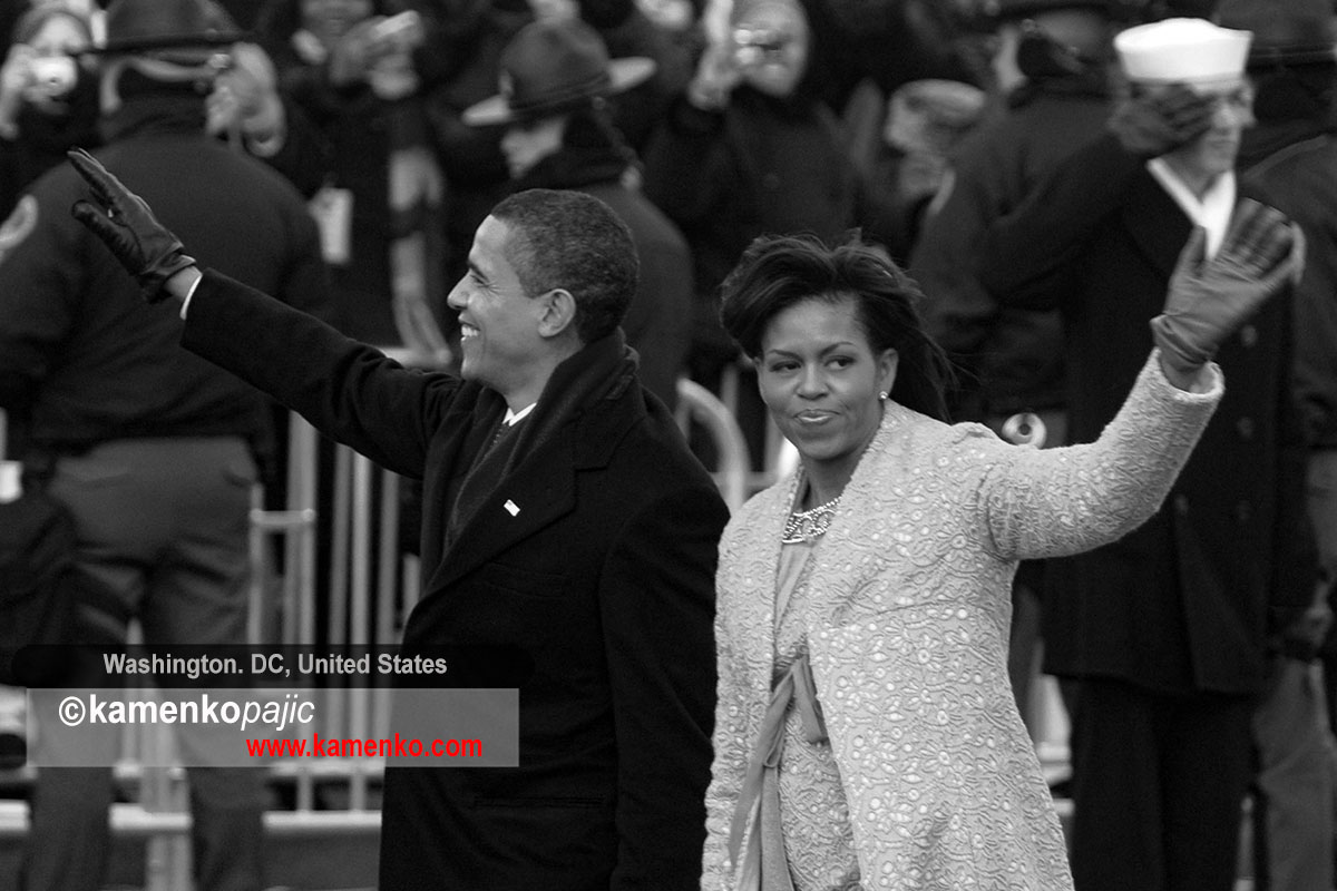 President Barack Obama and his wife Michelle wave while walking the parade route after the Inauguration Ceremony