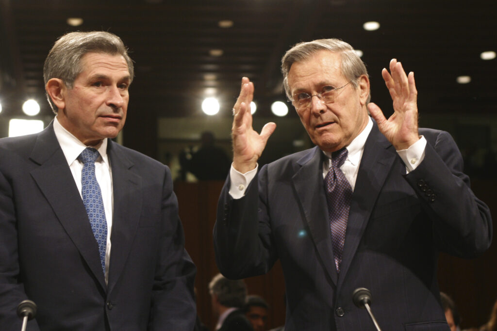Defense Secretary Donald Rumsfeld, right, speaks with Deputy Defense Secretary Paul Wolfowitz before they testify before the 9/11 Commission in Washington, March 23, 2004. The commission investigated the circumstances surrounding the Sept. 11, 2001, terrorist attacks and the nation’s preparedness and response.