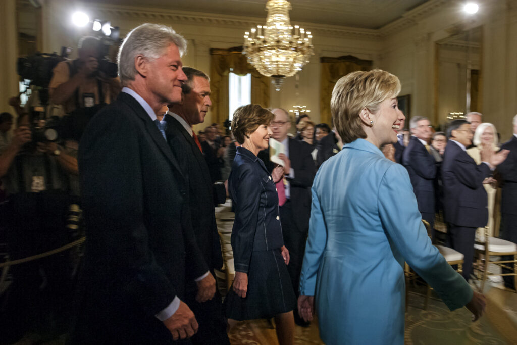 Sen. Hillary Rodham Clinton, D-N.Y., former President Bill Clinton, President George W. Bush and first lady Laura Bush arrive in the East Room of the White House for the unveiling of the Clintons’ official portraits in Washington, June 14, 2004.
